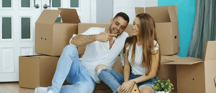 Couple surrounded by boxes in their new home