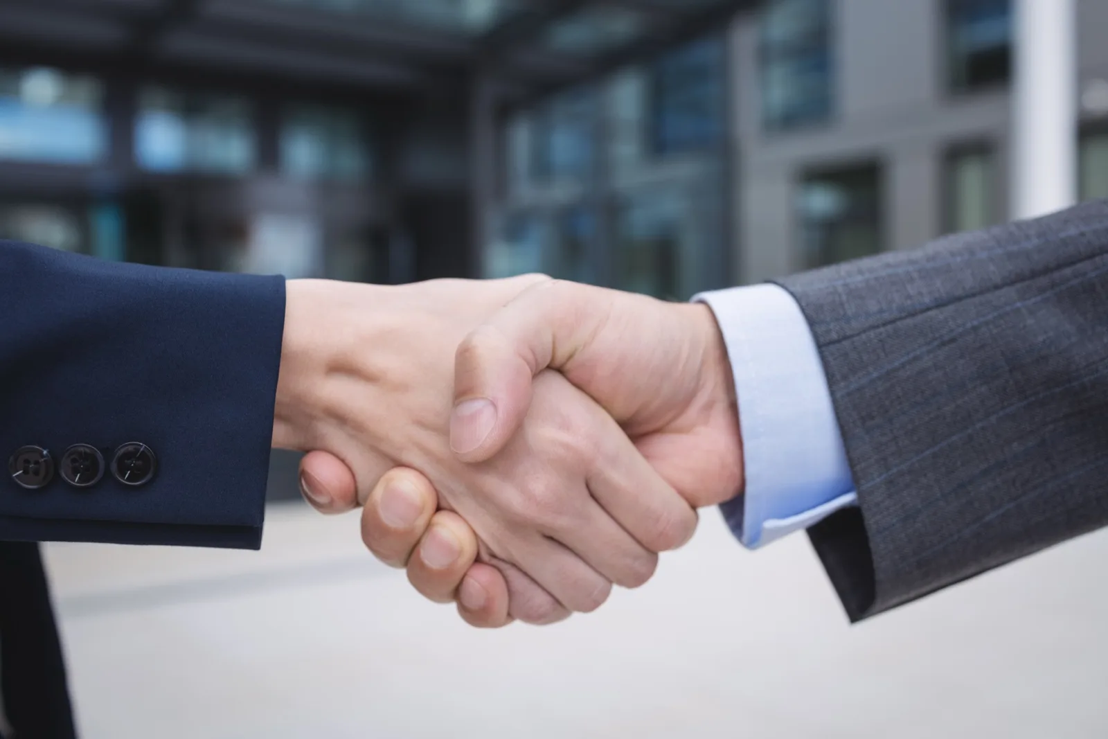 Business partners shaking hands after agreeing to work together.